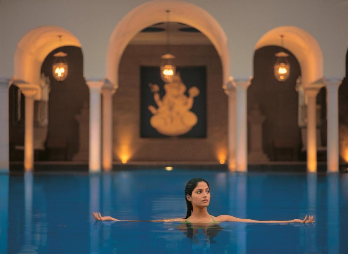 a woman in the swimming pool at The Oberoi Amarvilas Agra in Agra