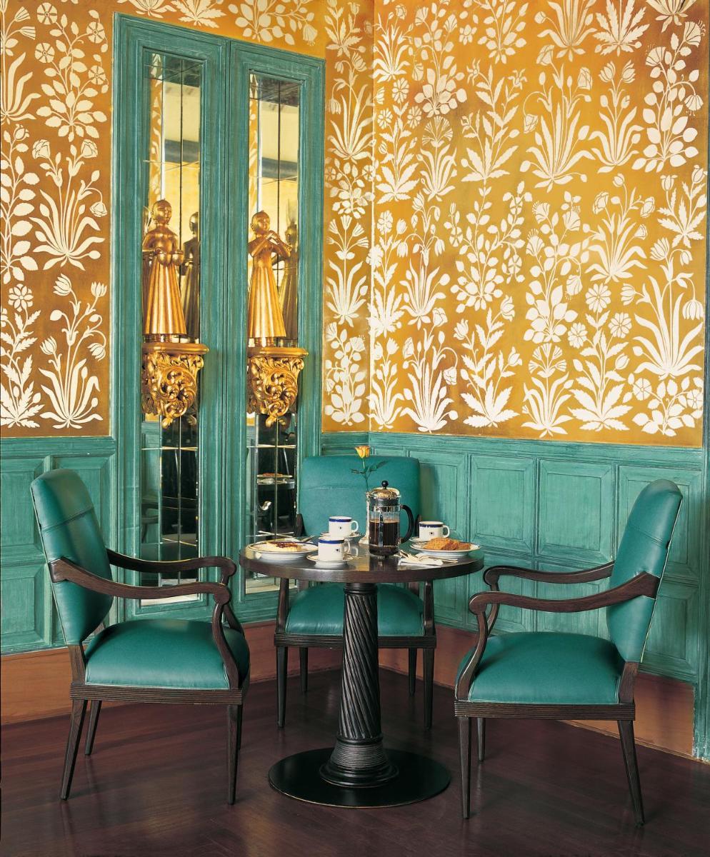 a dining room with a table and two chairs at The Oberoi Amarvilas Agra in Agra