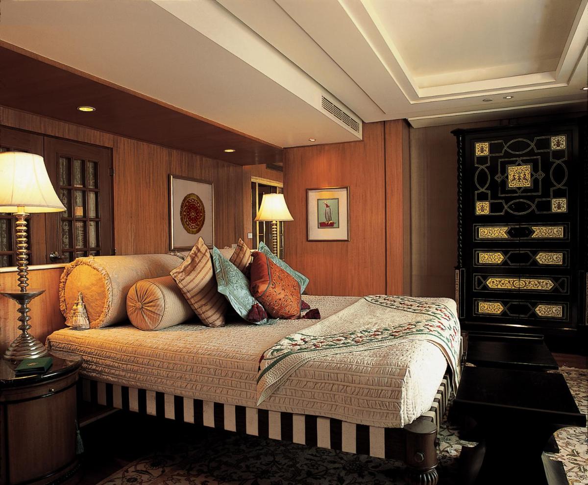 a bedroom with a bed with pillows on it at The Oberoi Amarvilas Agra in Agra