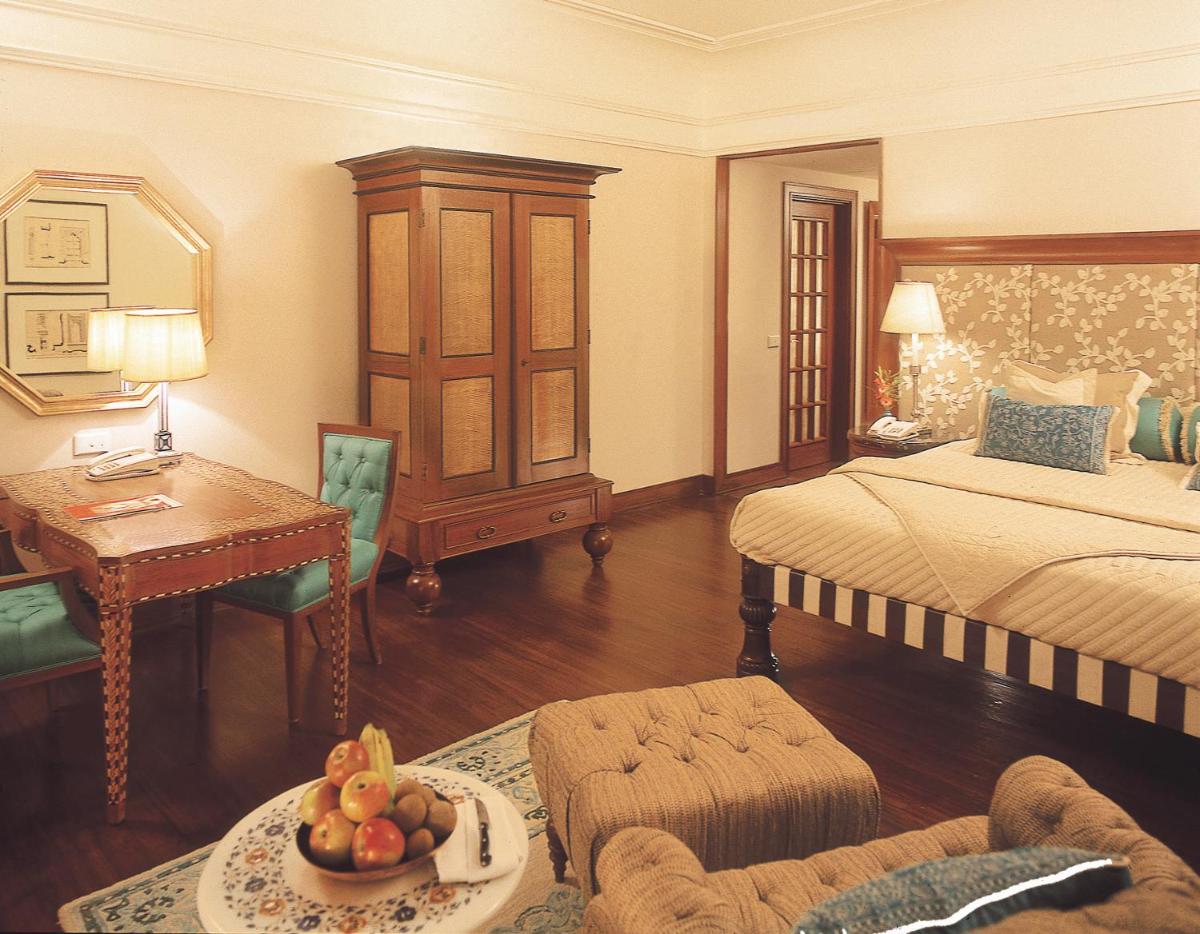 a bedroom with a bed and a table with a bowl of fruit at The Oberoi Amarvilas Agra in Agra