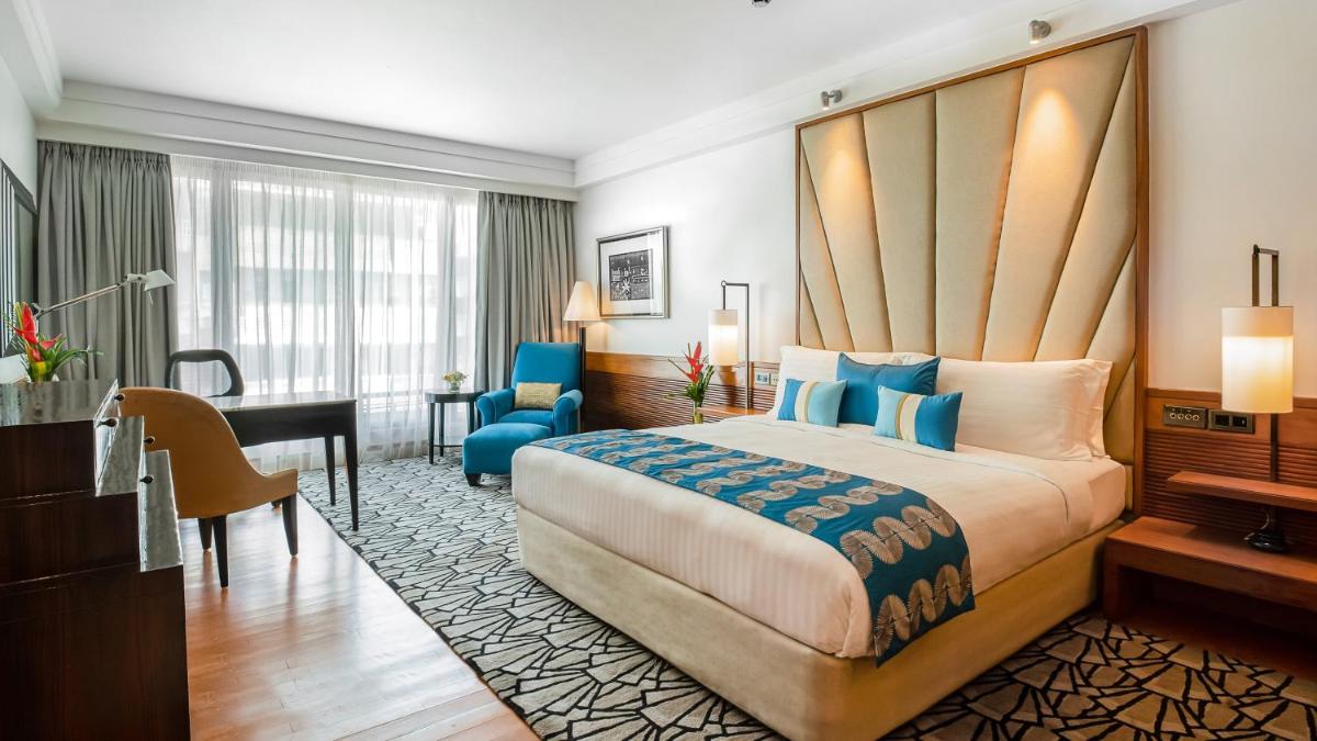 a hotel room with a large bed and a desk at InterContinental Marine Drive Mumbai by IHG in Mumbai
