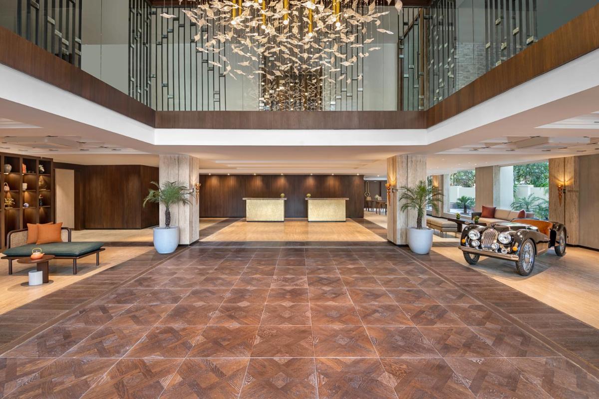 a lobby with a large chandelier and a large organ at Hyatt Centric Rajpur Road Dehradun in Dehradun