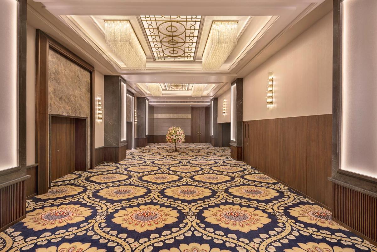 a hallway with a large tile floor in a building at Hyatt Centric Rajpur Road Dehradun in Dehradun
