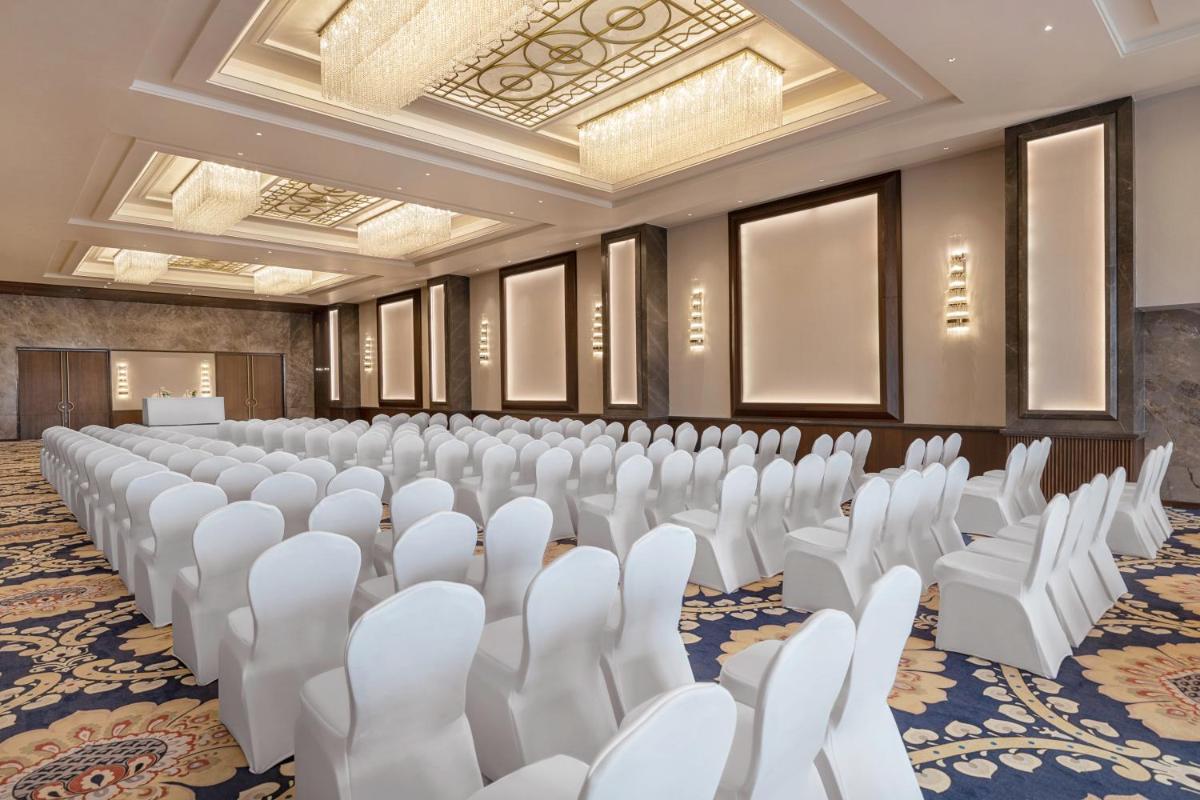 a conference room with white chairs and a podium at Hyatt Centric Rajpur Road Dehradun in Dehradun +70 photos