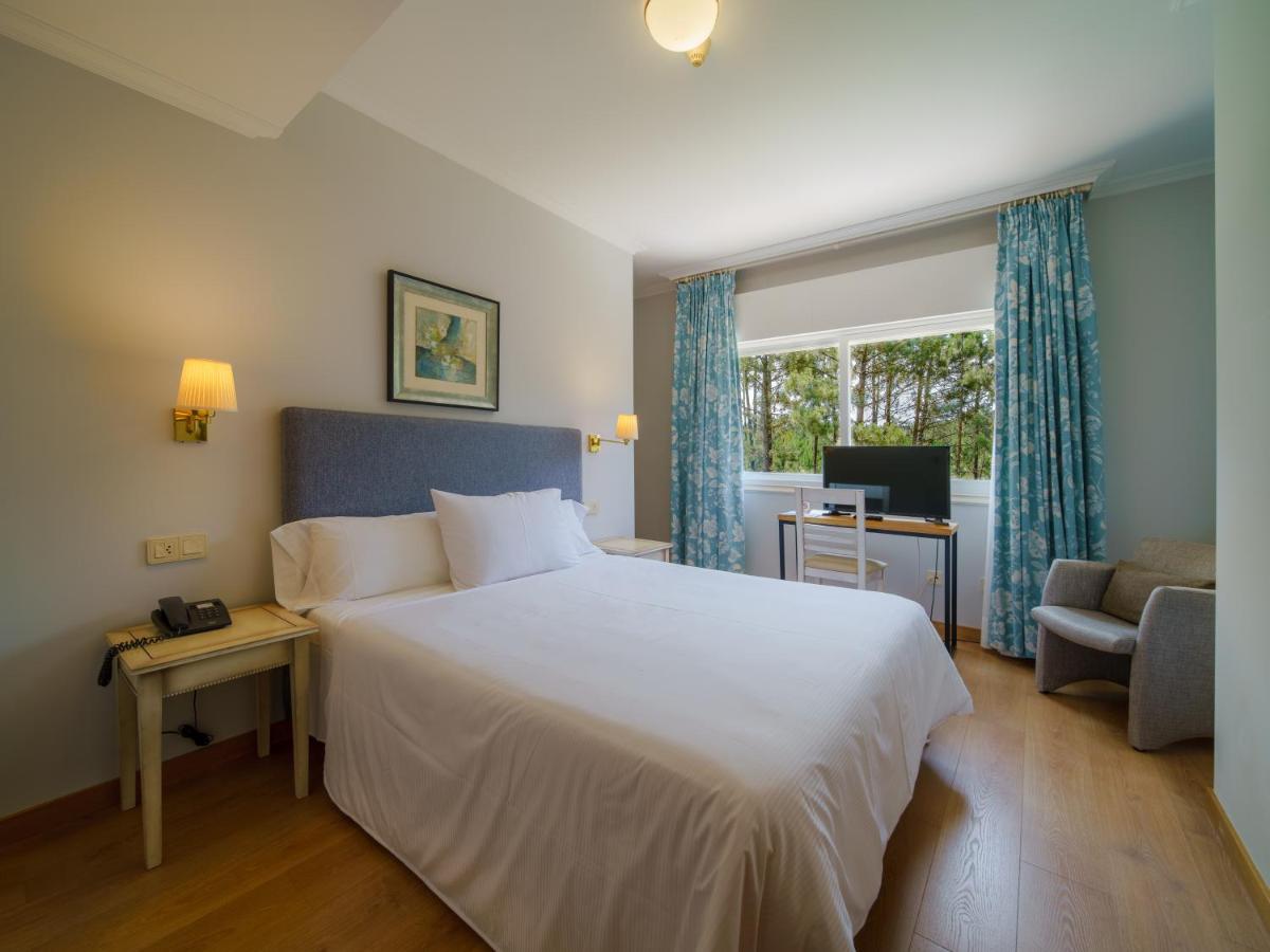 Cama o camas de una habitación en Hotel Spa Atlántico San Vicente do Mar
