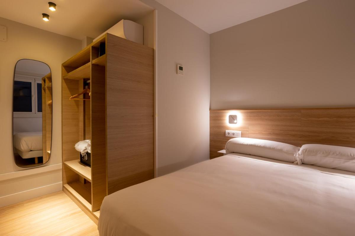 Cama o camas de una habitación en Apartamentos&Spa Mundakaport
