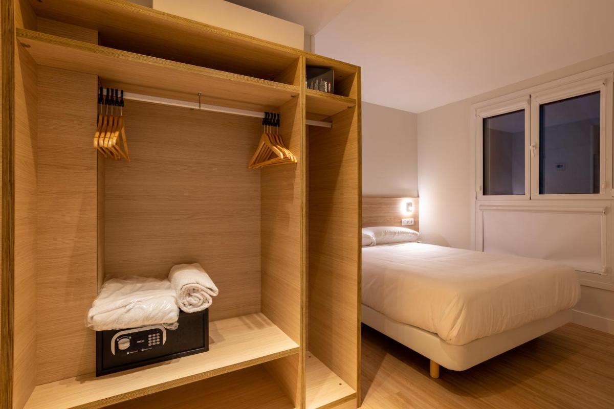 Cama o camas de una habitación en Apartamentos&Spa Mundakaport