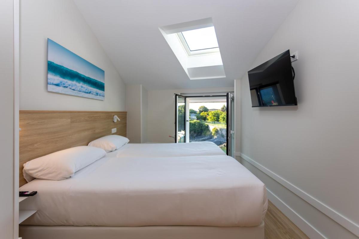 Cama o camas de una habitación en Apartamentos&Spa Mundakaport