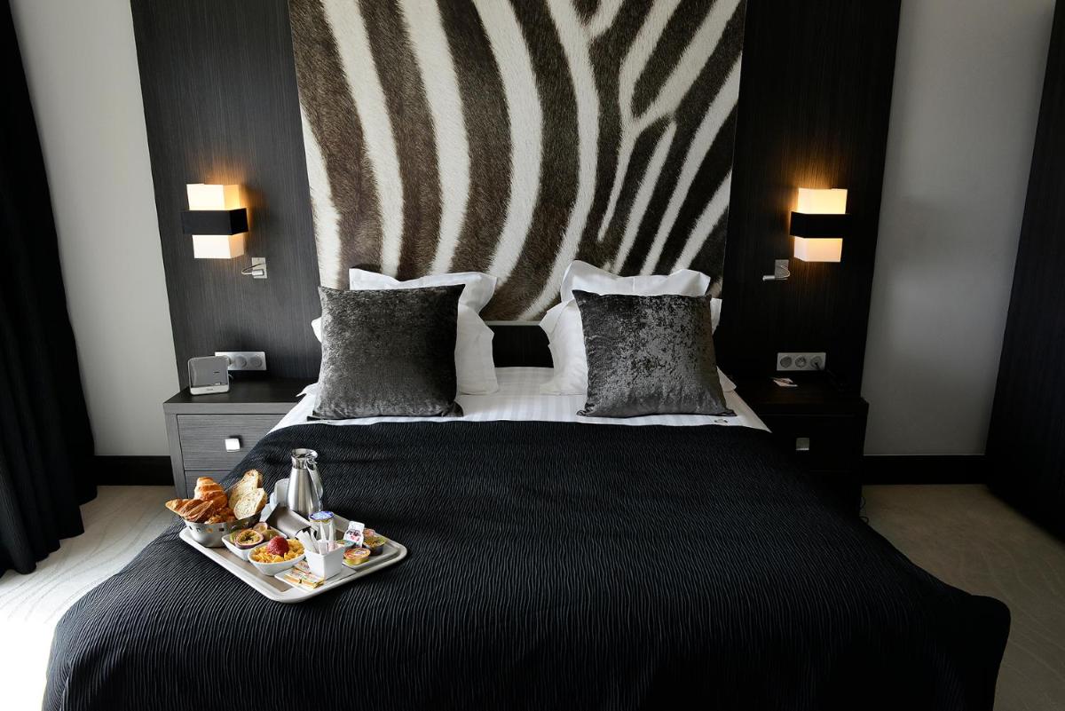 Un ou plusieurs lits dans un hébergement de l'établissement Kyriad Prestige Lyon Est - Saint Priest Eurexpo Hotel and SPA