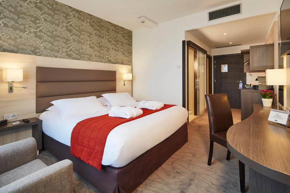 Un ou plusieurs lits dans un hébergement de l'établissement Kyriad Prestige Lyon Est - Saint Priest Eurexpo Hotel and SPA