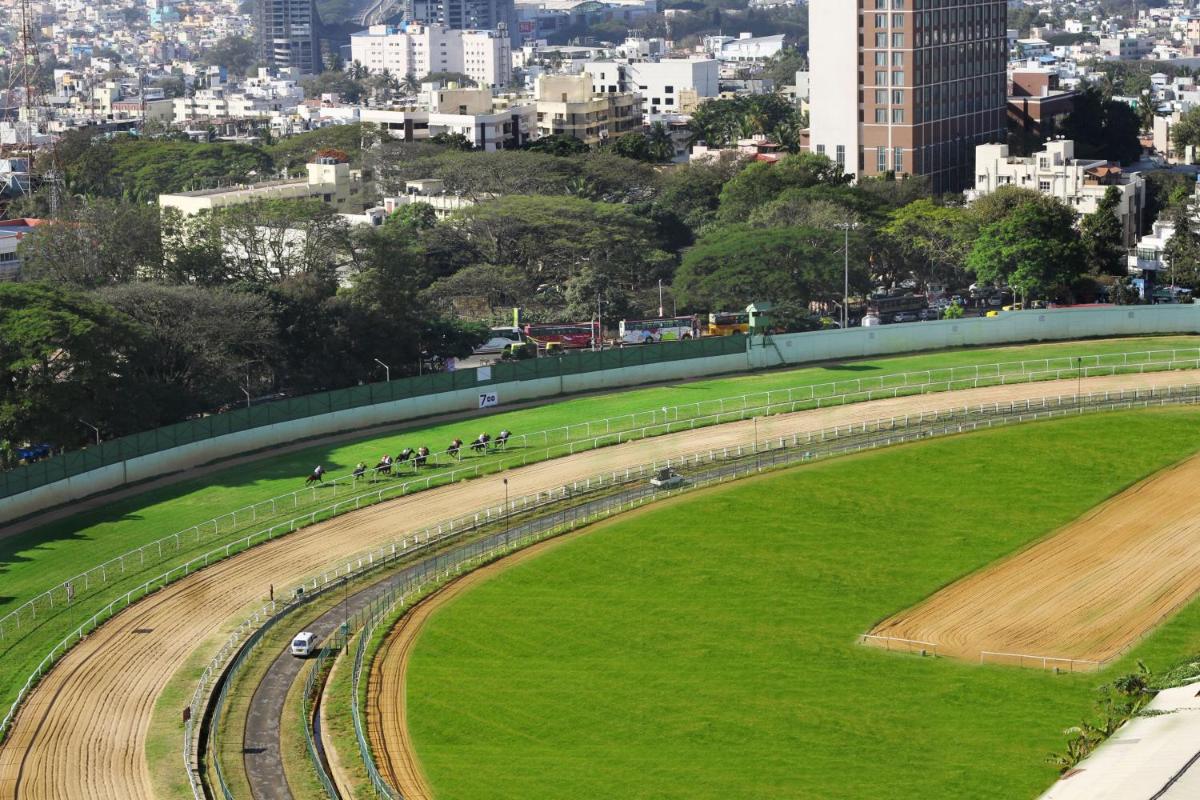 a race track in a field with a city in the background at Holiday Inn Bengaluru Racecourse by IHG in Bengaluru a race track in a field with a city in the background at Holiday Inn Bengaluru Racecourse by IHG in Bengaluru