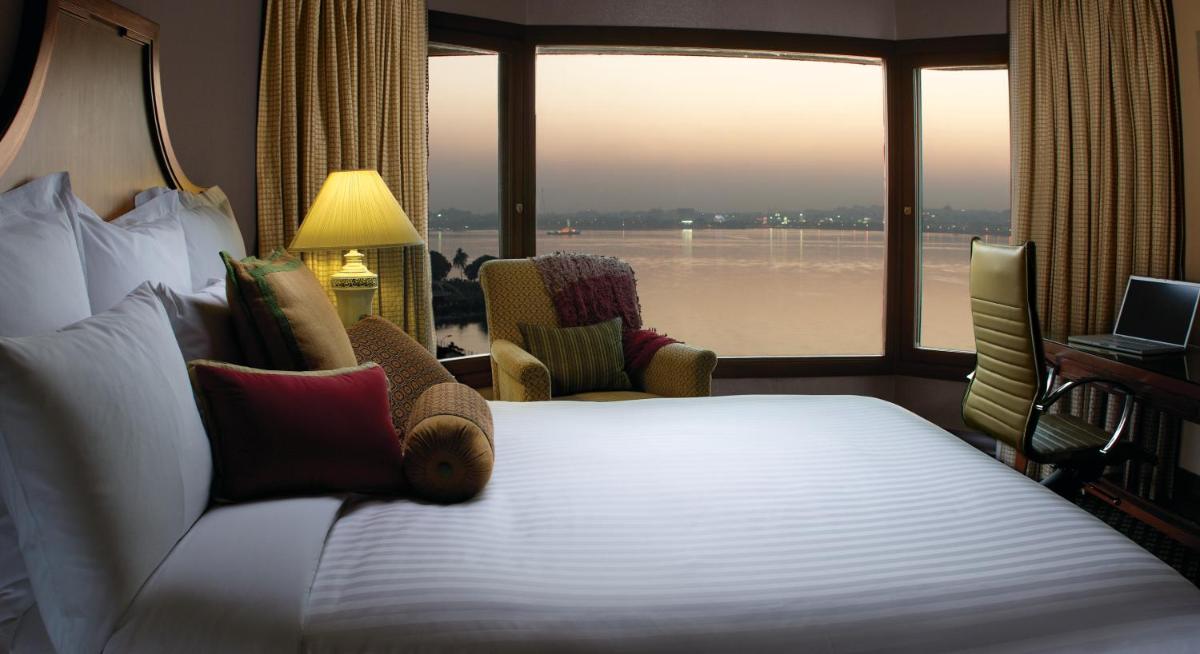 a hotel room with a bed and a large window at Hyderabad Marriott Hotel & Convention Centre in Hyderabad