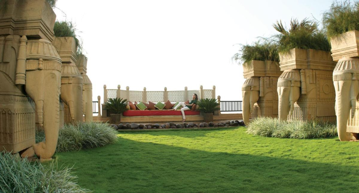 a garden with a building with grass and plants at Hyderabad Marriott Hotel & Convention Centre in Hyderabad