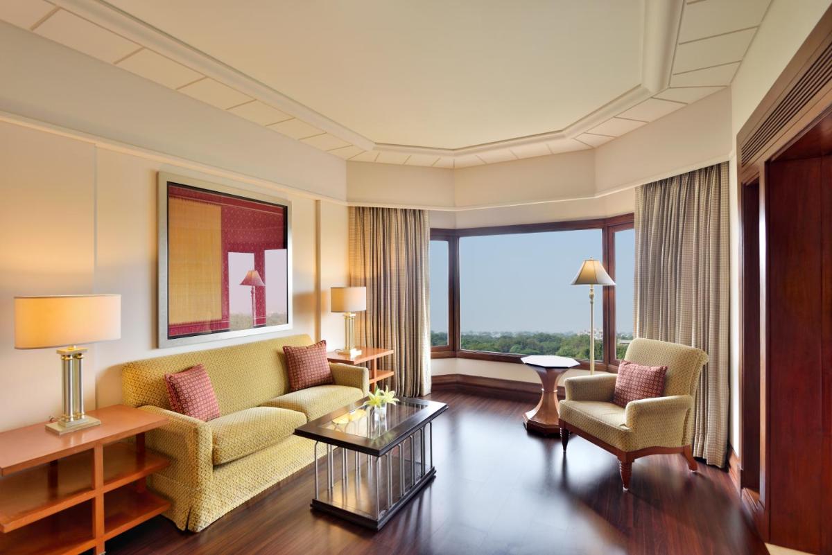a living room with a couch and two chairs at Hyderabad Marriott Hotel & Convention Centre in Hyderabad