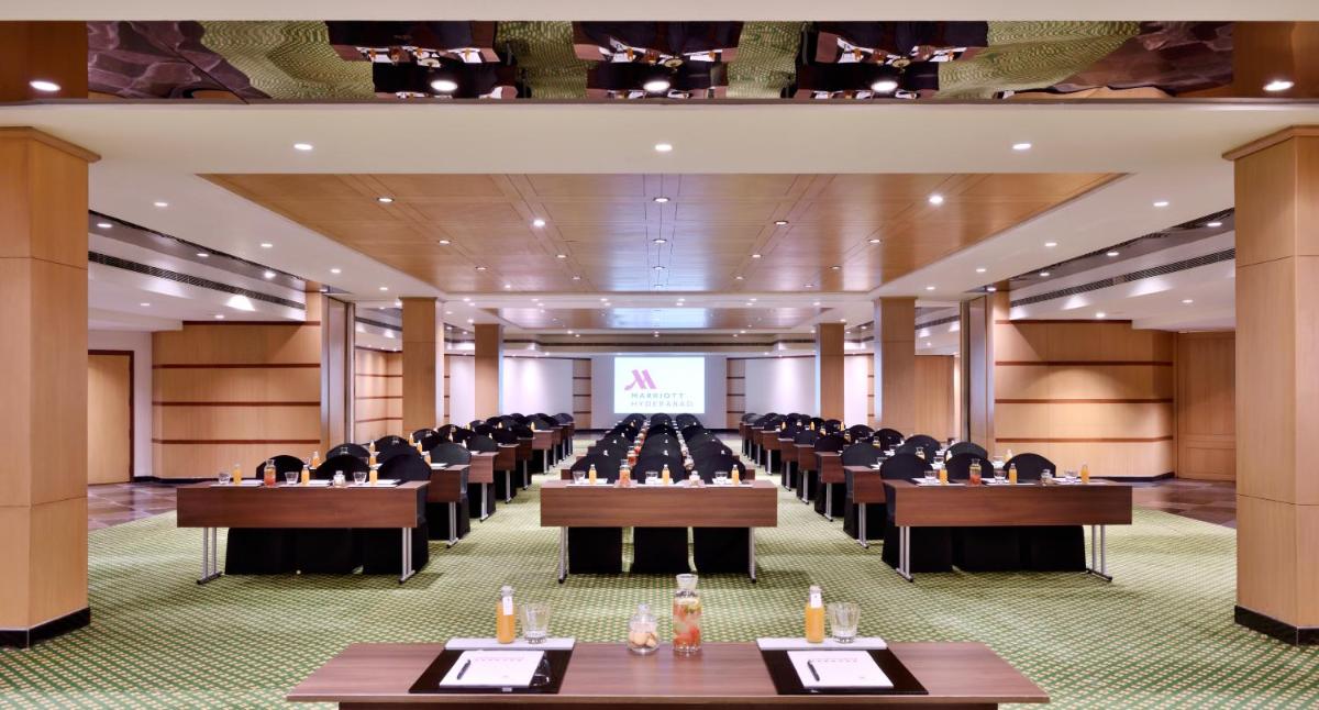a large room with rows of tables and chairs at Hyderabad Marriott Hotel & Convention Centre in Hyderabad