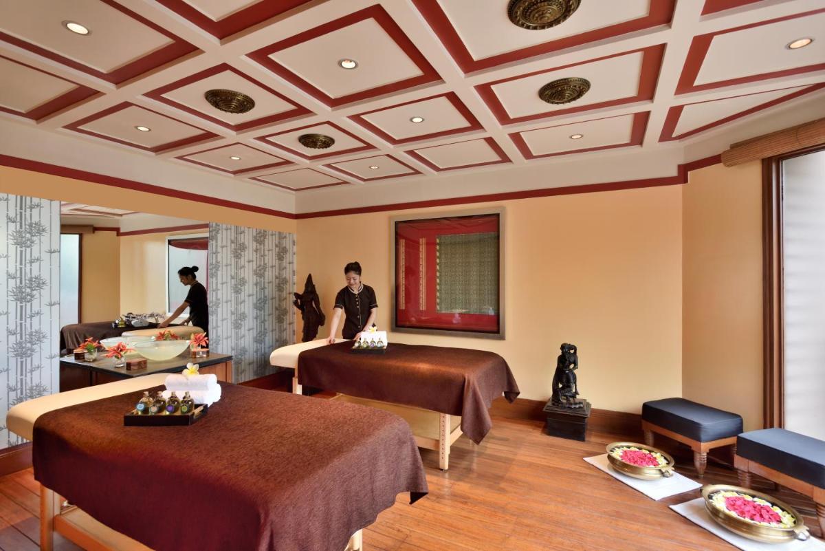 a hotel room with two beds and a bathroom at Hyderabad Marriott Hotel & Convention Centre in Hyderabad