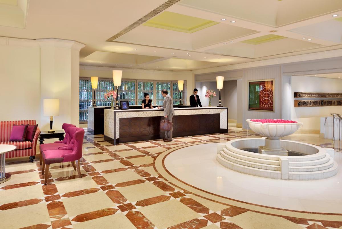 a lobby of a hotel with a reception desk at Hyderabad Marriott Hotel & Convention Centre in Hyderabad