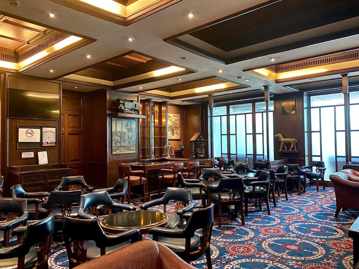 a restaurant with a lot of chairs and tables at Taj Bengal in Kolkata