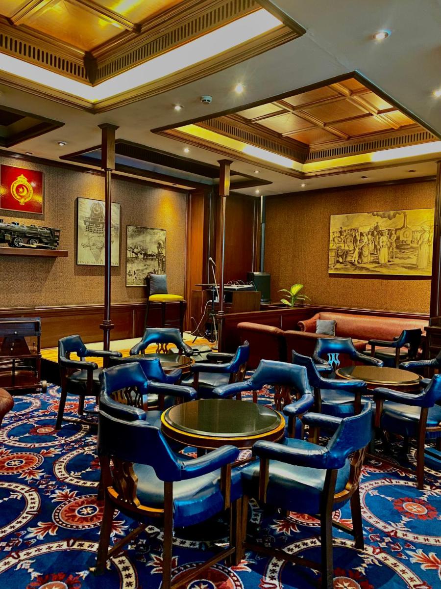 a restaurant with blue chairs and tables in a room at Taj Bengal in Kolkata