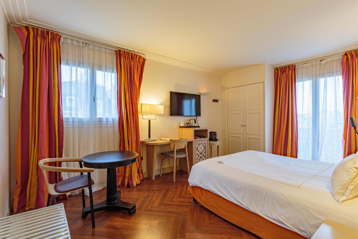 Un ou plusieurs lits dans un hébergement de l'établissement Grand Tonic Hotel & SPA NUXE
