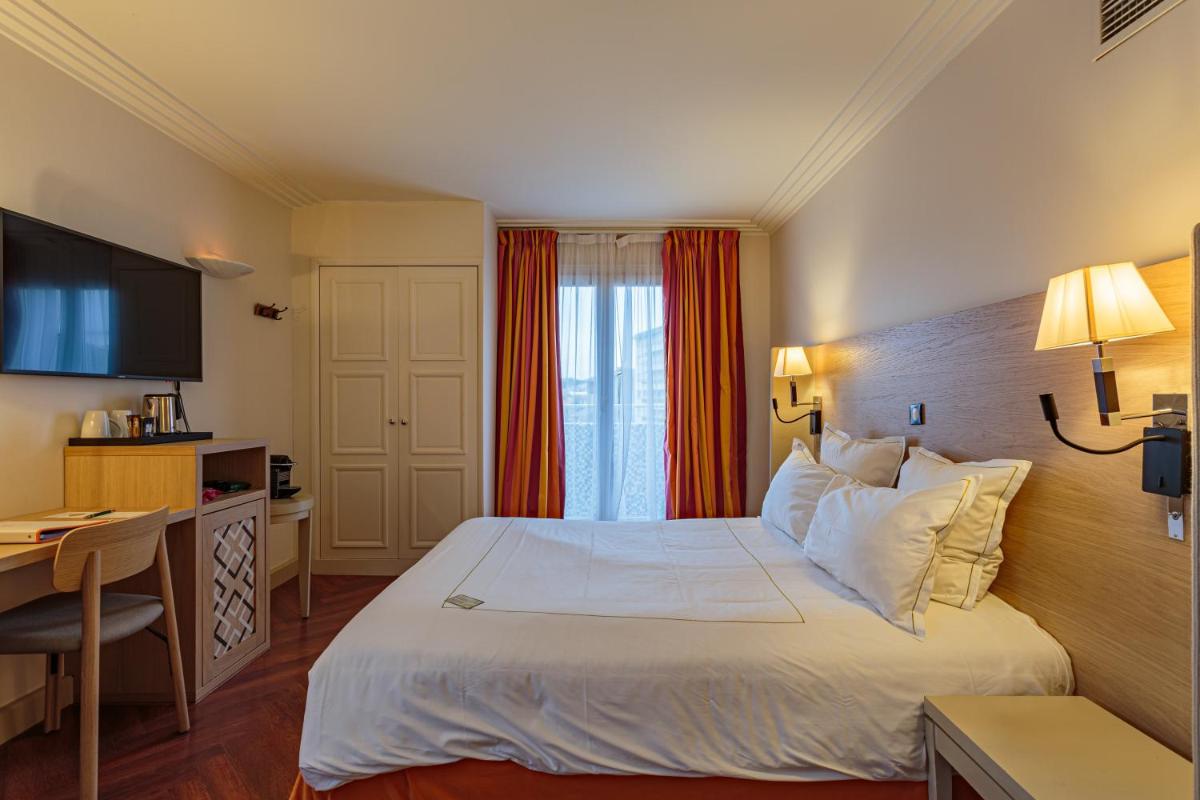 Un ou plusieurs lits dans un hébergement de l'établissement Grand Tonic Hotel & SPA NUXE