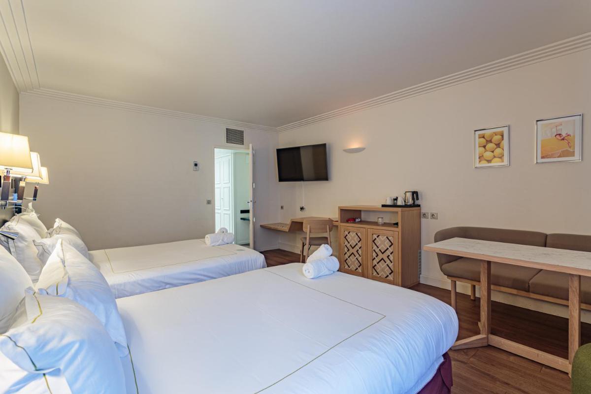 Un ou plusieurs lits dans un hébergement de l'établissement Grand Tonic Hotel & SPA NUXE