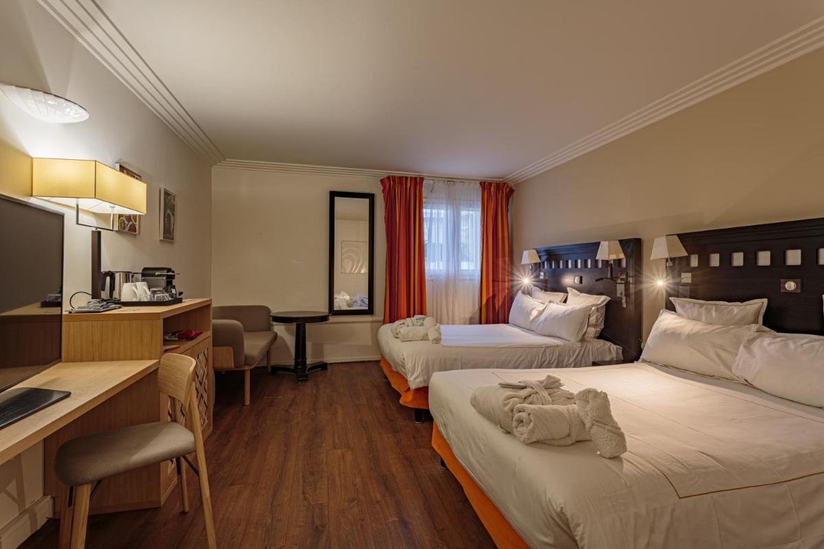 Un ou plusieurs lits dans un hébergement de l'établissement Grand Tonic Hotel & SPA NUXE