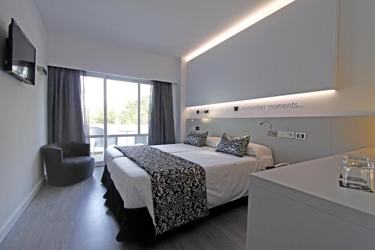 una habitación de hotel con una cama y una silla en BG Pamplona, en Playa de Palma