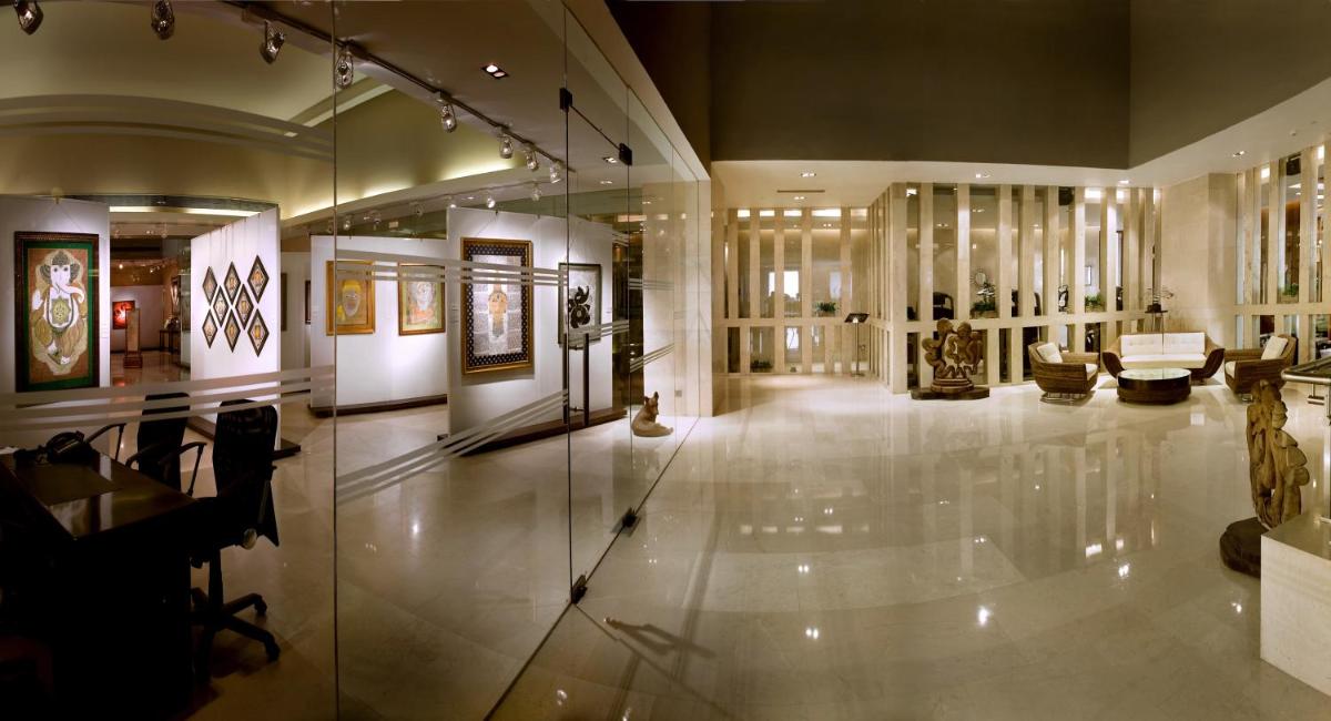 a large room with a museum with artifacts on display at The LaLiT New Delhi in New Delhi