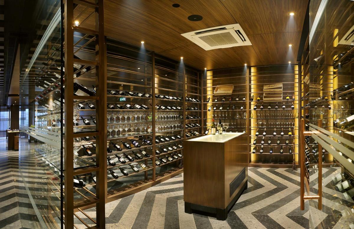 a wine tasting room with a large wine cellar at The LaLiT New Delhi in New Delhi
