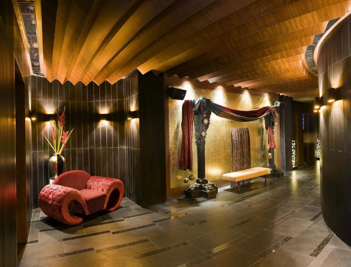 a room with a stage with a chair and a bench at The LaLiT New Delhi in New Delhi