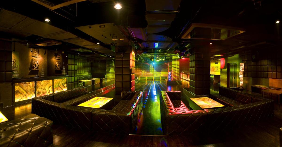 a room with a stage with chairs and lights at The LaLiT New Delhi in New Delhi