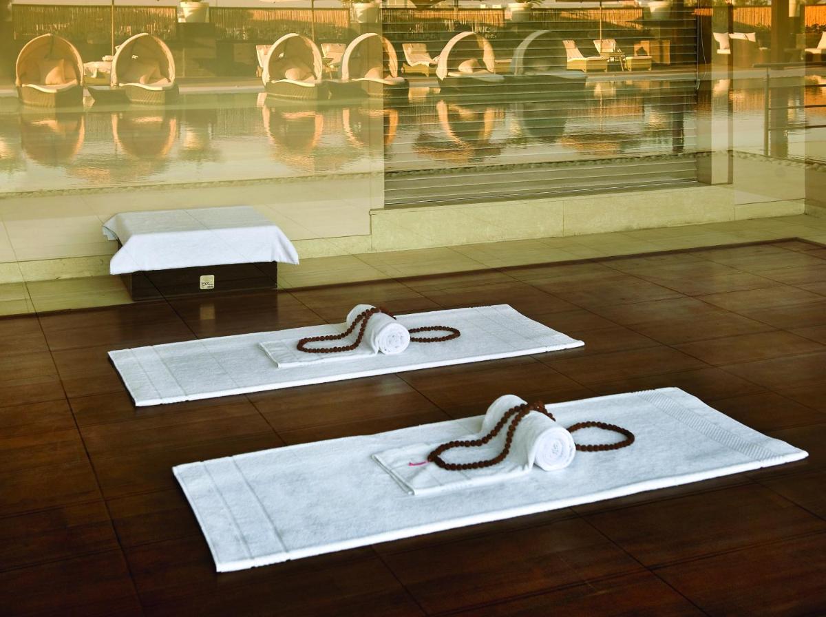three white towels on the floor in a store window at The LaLiT New Delhi in New Delhi