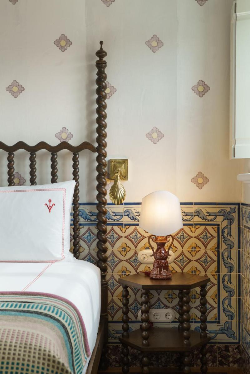 Uma cama ou camas num quarto em Vermelho Melides - Relais & Châteaux