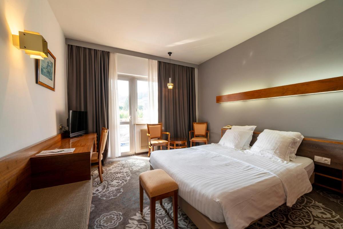 Un ou plusieurs lits dans un hébergement de l'établissement Hotel Munsch Restaurant & Wellness, Colmar Nord - Haut-Koenigsbourg