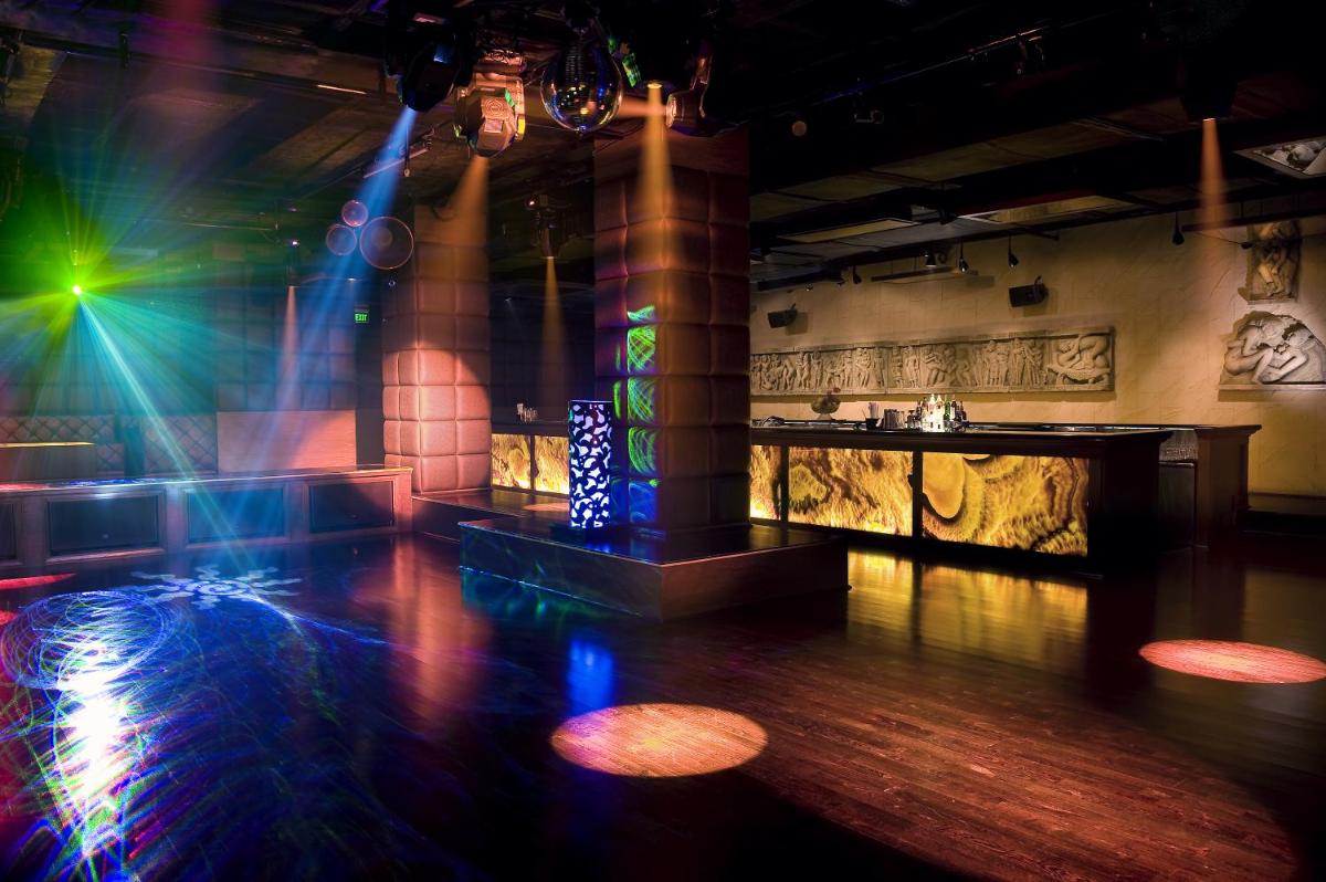 a room with a dance floor with lights on it at The LaLiT New Delhi in New Delhi