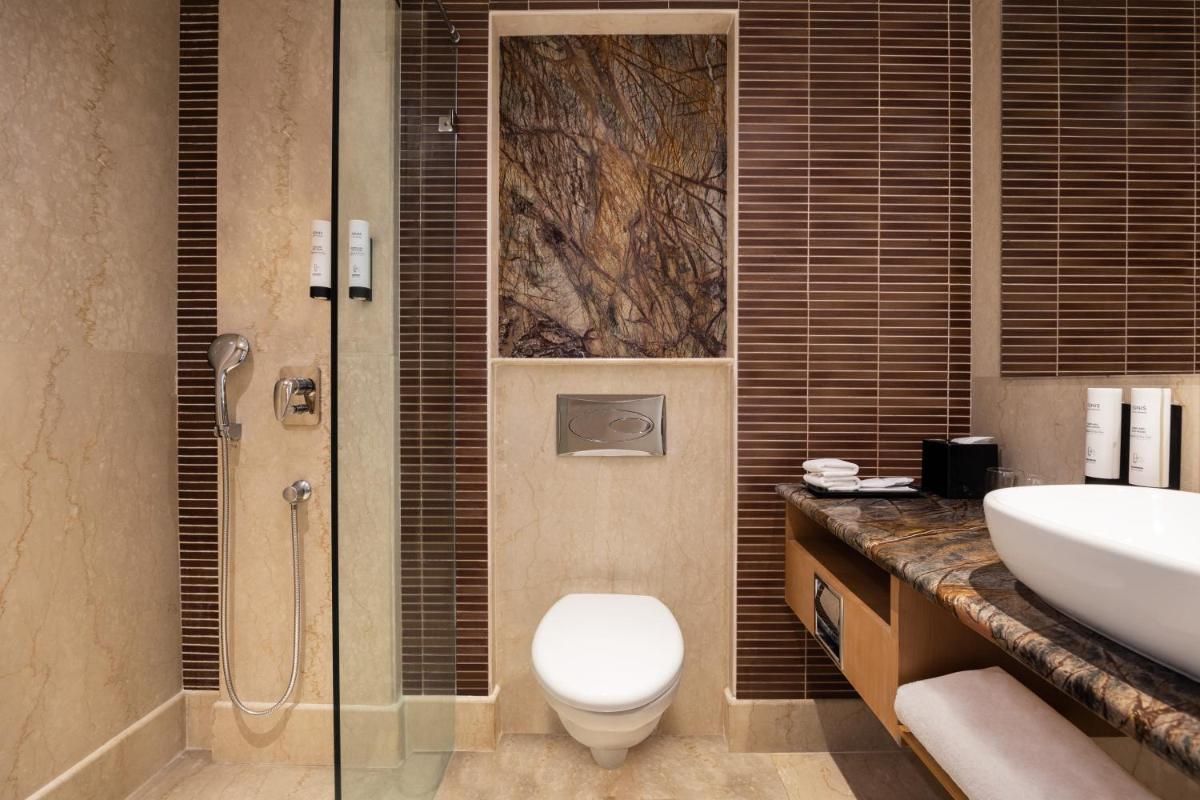 a bathroom with a toilet and a sink and a shower at Fairfield by Marriott Jaipur in Jaipur