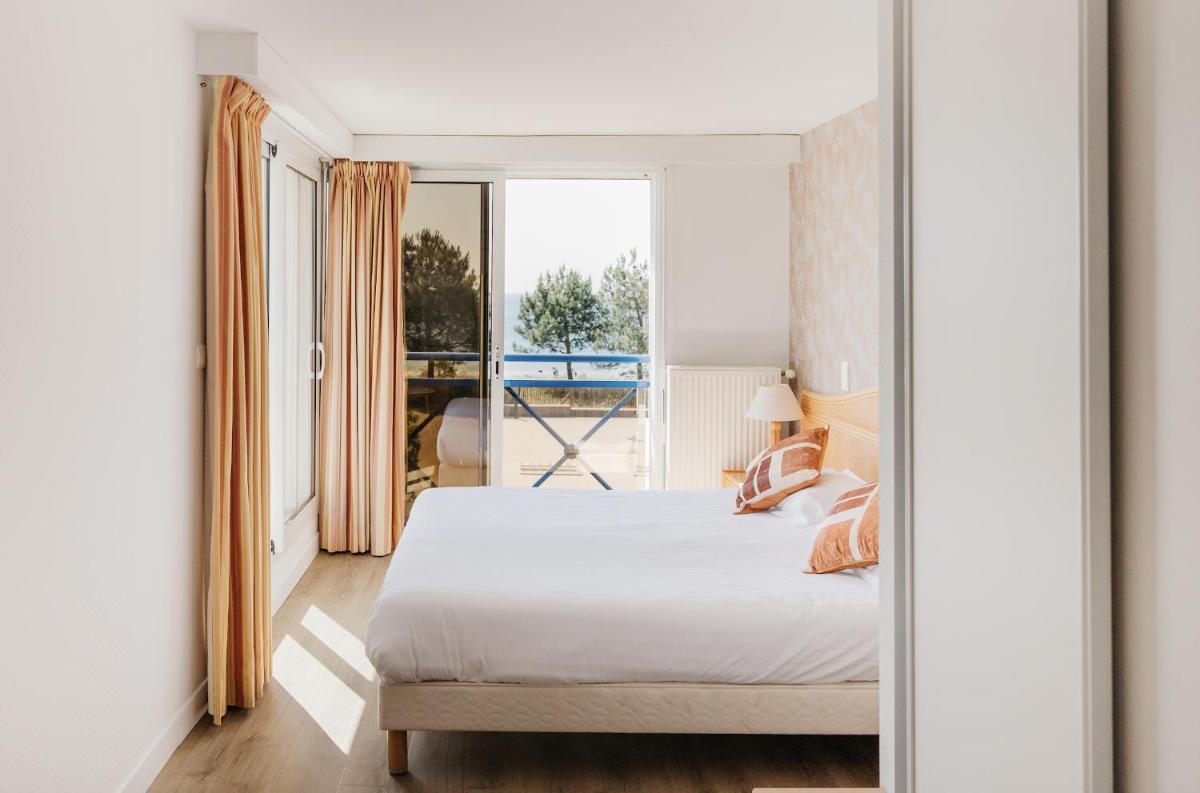 Un ou plusieurs lits dans un hébergement de l'établissement Hôtel Édenia - Spa Estime&Sens