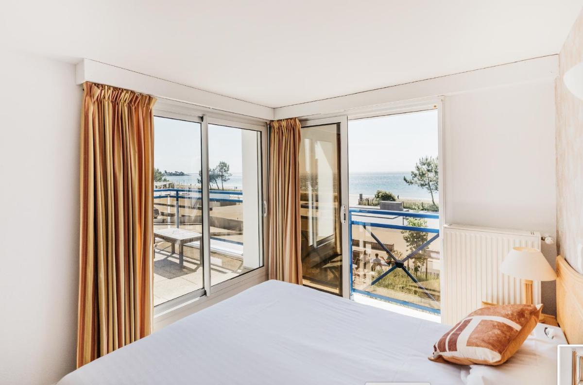 Un ou plusieurs lits dans un hébergement de l'établissement Hôtel Édenia - Spa Estime&Sens