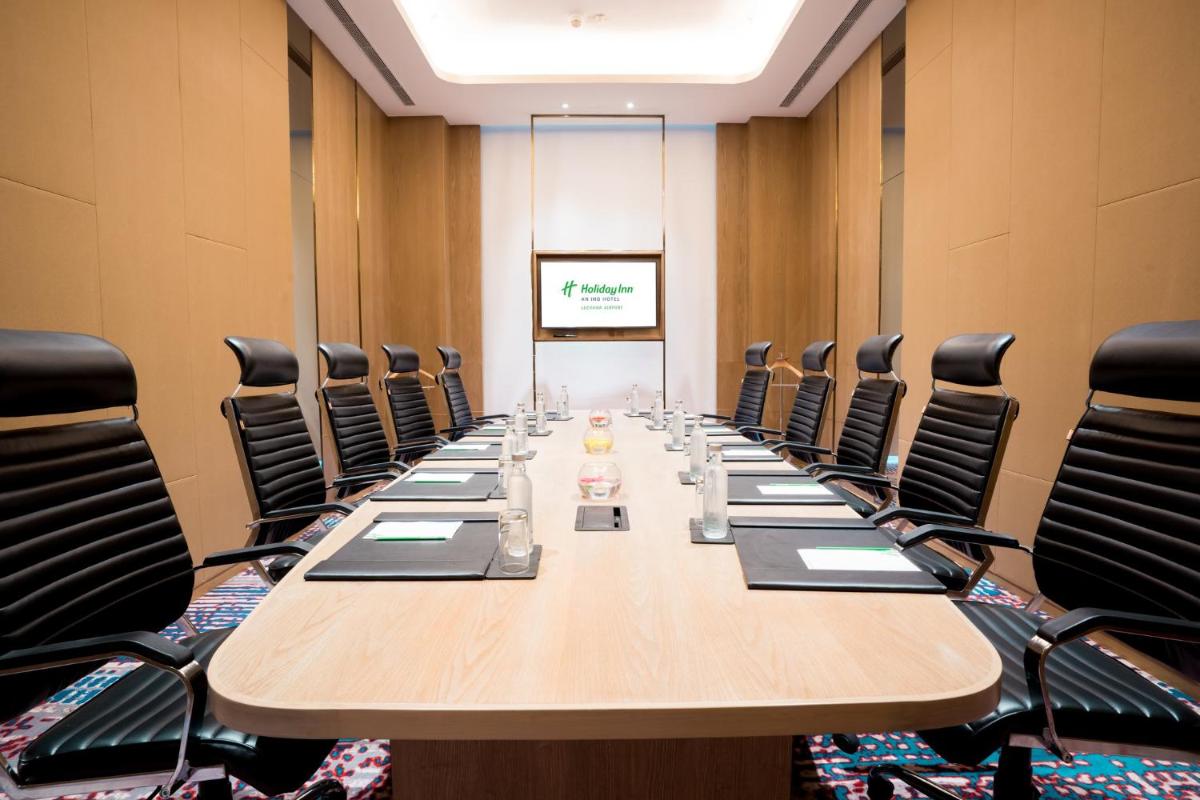 a conference room with a long table and chairs at Holiday Inn Lucknow Airport by IHG in Lucknow