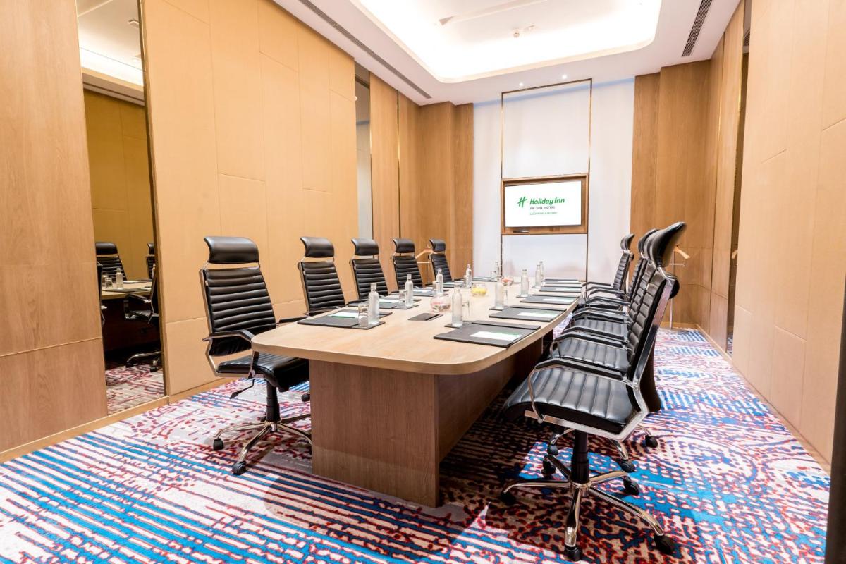 a conference room with a long table and chairs at Holiday Inn Lucknow Airport by IHG in Lucknow