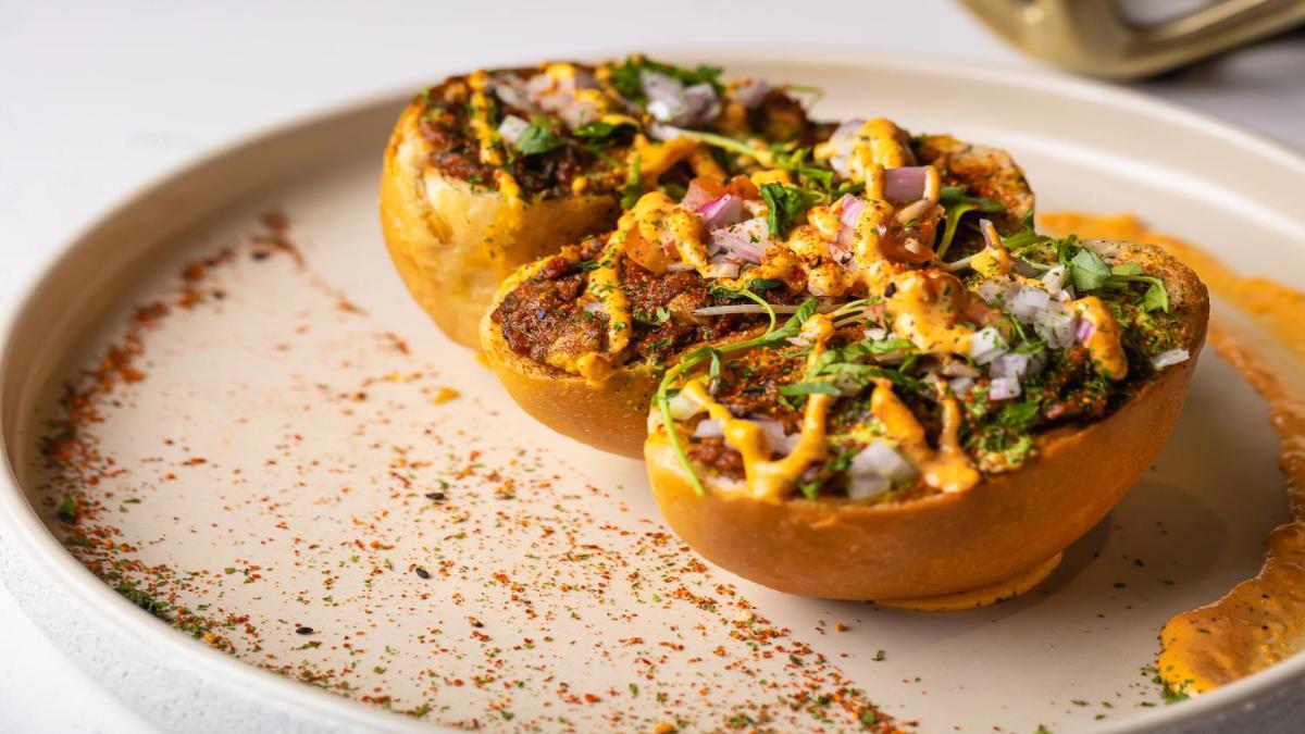a plate of food with two small appetizers on it at Novotel Mumbai International Airport in Mumbai