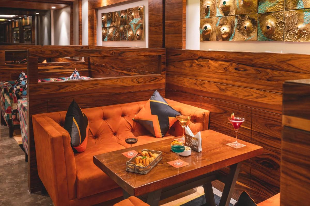 a dining room with a couch and a table at Welcomhotel by ITC Hotels, Shimla in Shimla