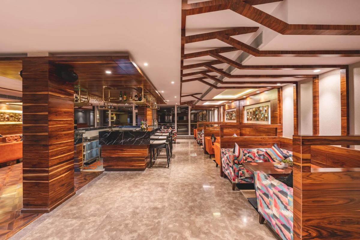 a restaurant with wooden walls and tables and chairs at Welcomhotel by ITC Hotels, Shimla in Shimla
