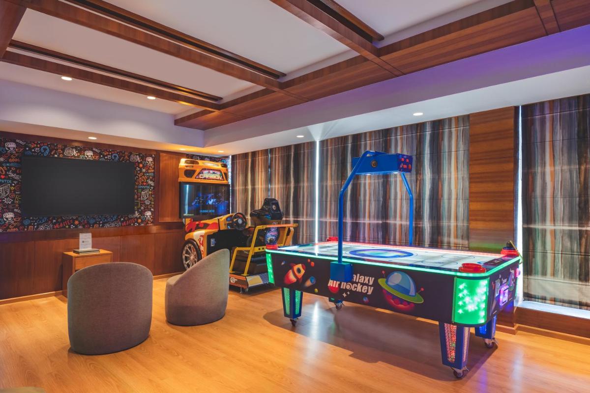 a room with a pool table and a flat screen tv at Welcomhotel by ITC Hotels, Shimla in Shimla
