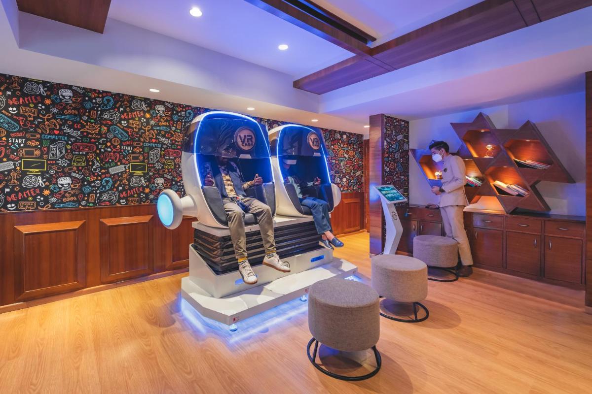 a room with an art exhibit with a mannequin and chairs at Welcomhotel by ITC Hotels, Shimla in Shimla