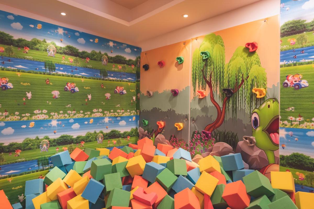 a room with a dinosaur mural on the wall at Welcomhotel by ITC Hotels, Shimla in Shimla