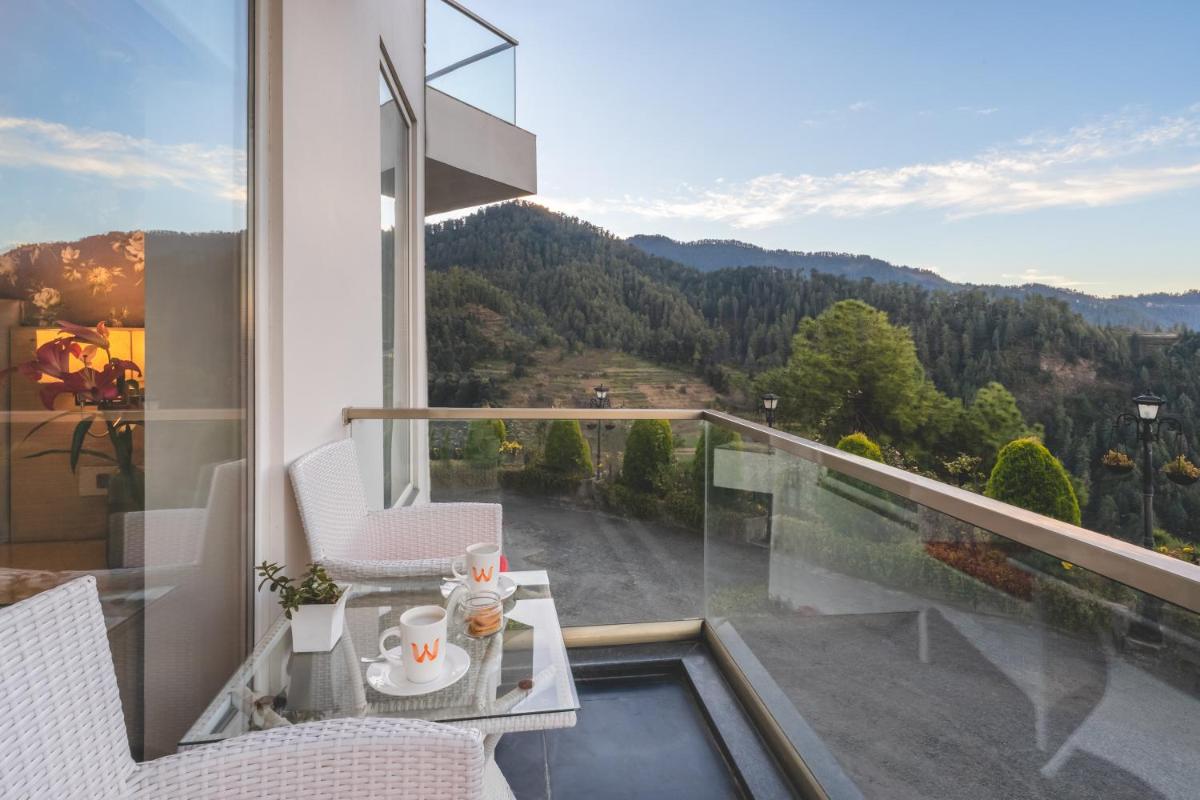 a balcony with a table and chairs and a view at Welcomhotel by ITC Hotels, Shimla in Shimla