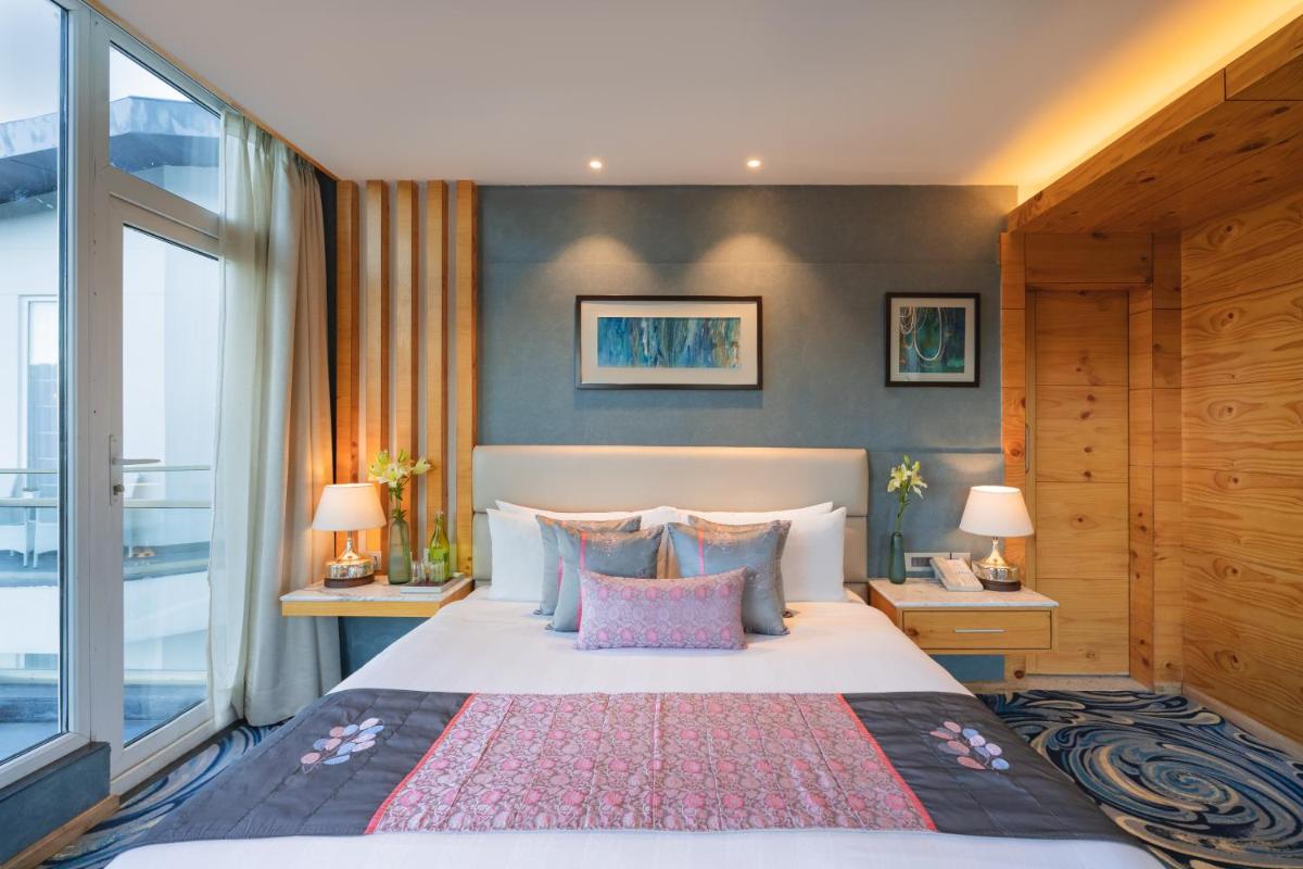 a bedroom with a large bed and a large window at Welcomhotel by ITC Hotels, Shimla in Shimla +70 photos