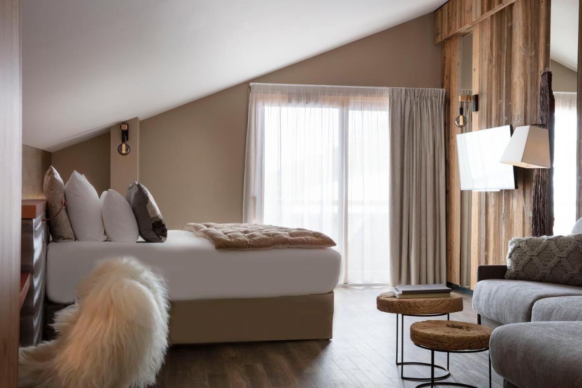 Un ou plusieurs lits dans un hébergement de l'établissement Grandes Rousses Hotel & Spa
